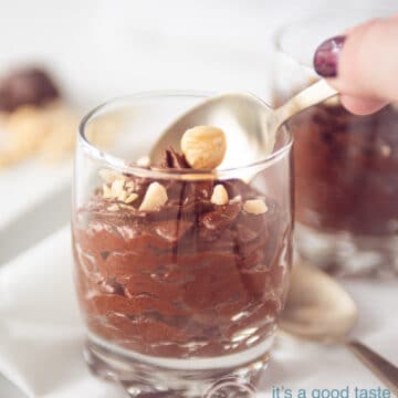 A hand which takes a bite of chocolate mousse