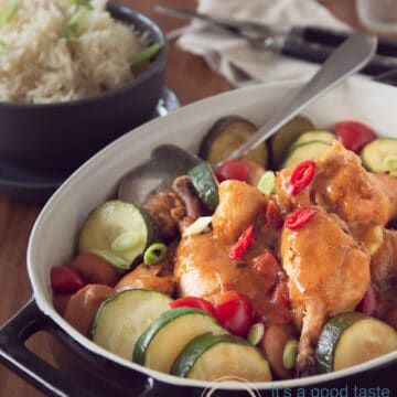 A black casserole dish filled with homemade gumbo with chicken and sausage
