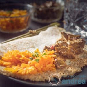A square photo with a stuffed appam with braised beef and tropical carrots