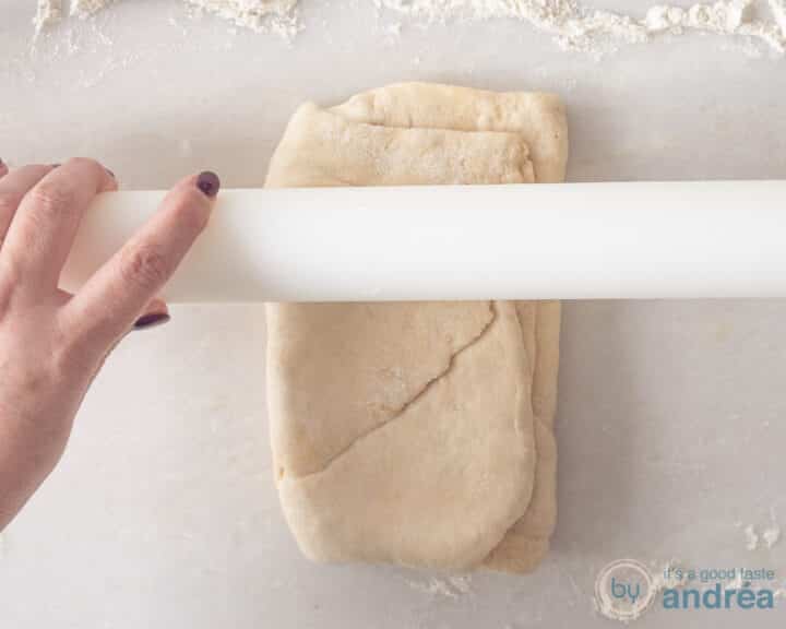Roll out the dough with a white rolling pin.
