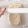 Roll out the dough with a white rolling pin.