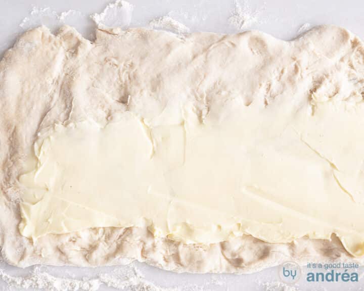 A piece of dough on which butter has been spread.
