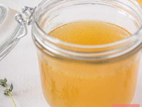 A square picture with a pot filled with chicken stock