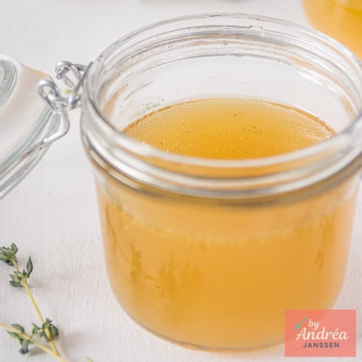 A square picture with a pot filled with chicken stock