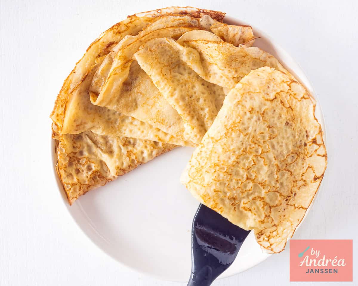 Crepes layered on a white plate