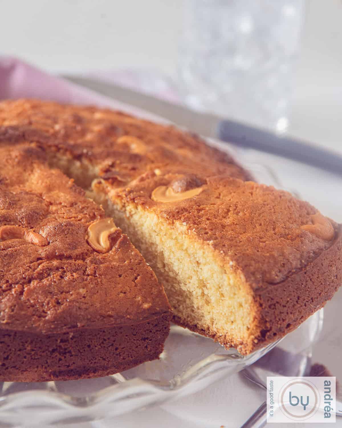 A slice of an Indian Mawa Cake with a point cut out of it.
