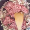Minced meat is added to the frying pan with the fried bacon and onion.