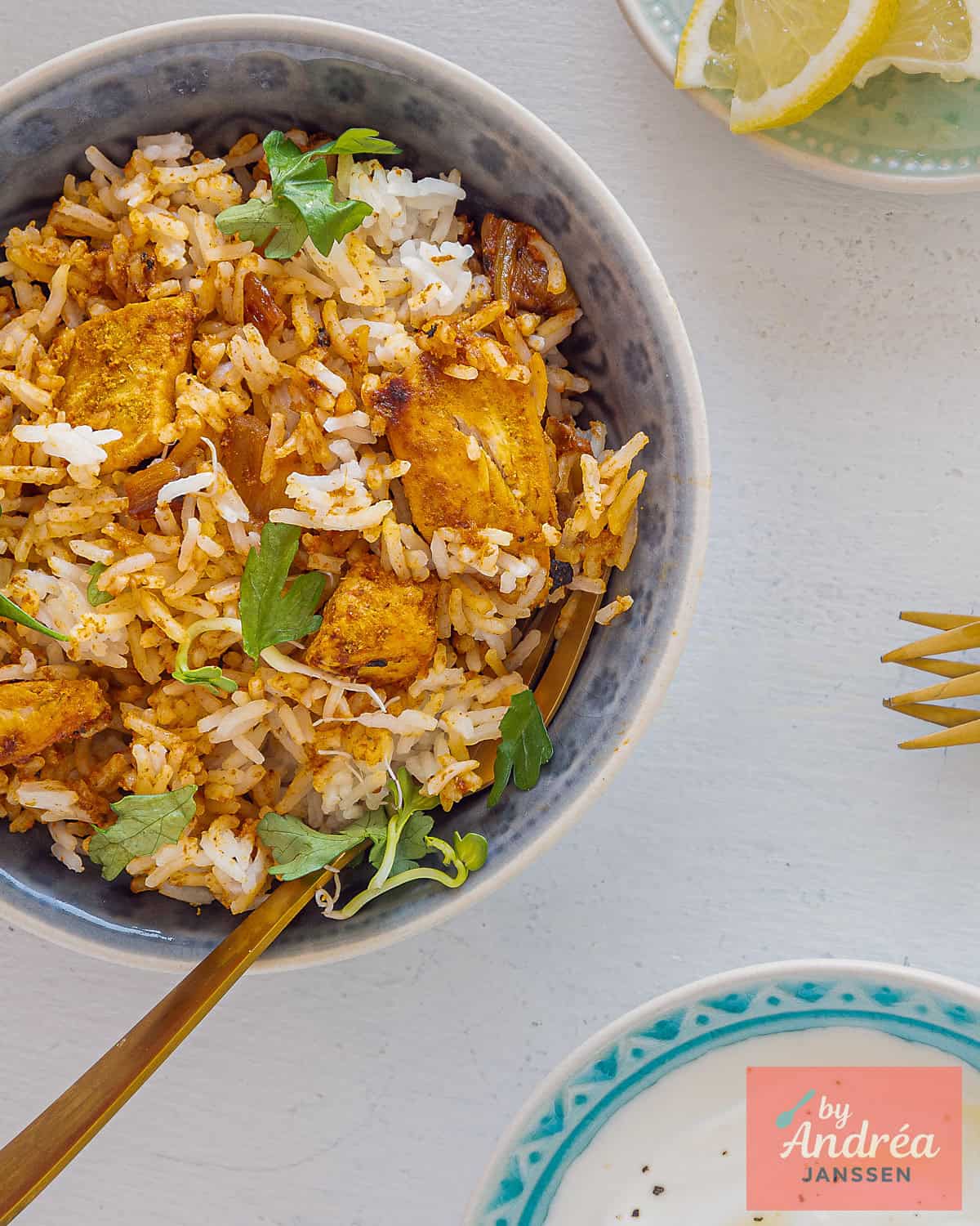 A photo from above of a grey bowl filled with homemade Chicken Tikka Biryani