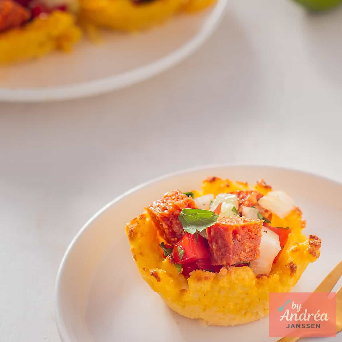 A square picture with a polenta cup filled with tomatoes.