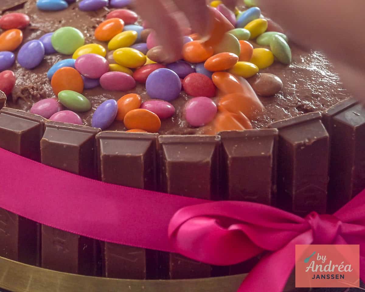 A wide photo with part of a KitKat Smarties cake