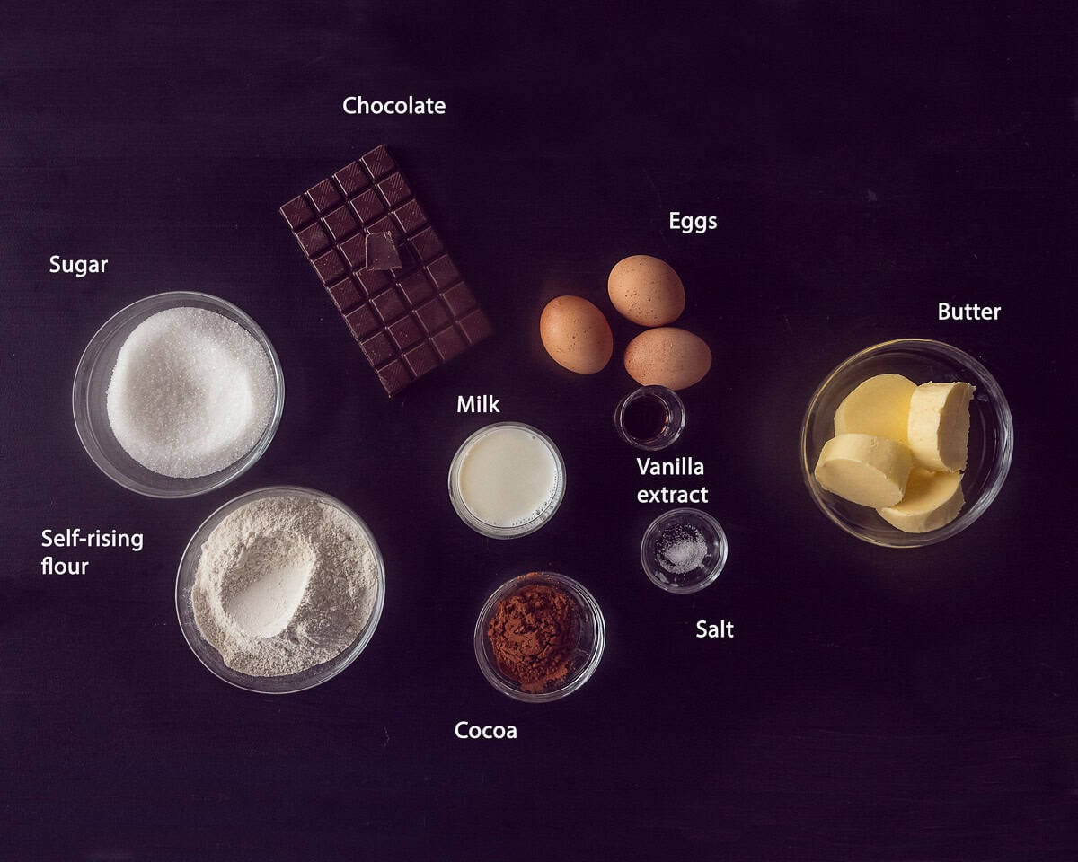 Ingredients chocolate cake on a black background with text description.