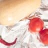 Pumpkin, pepper and tomatoes lie on aluminum foil