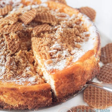 Stroopwafel cheesecake on a white plate a piece of cheesecake is taken out.