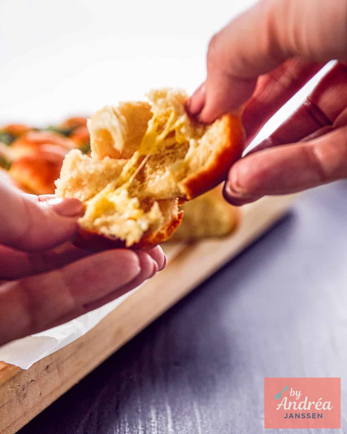 A photo of a ball being broken open, revealing the cheese.