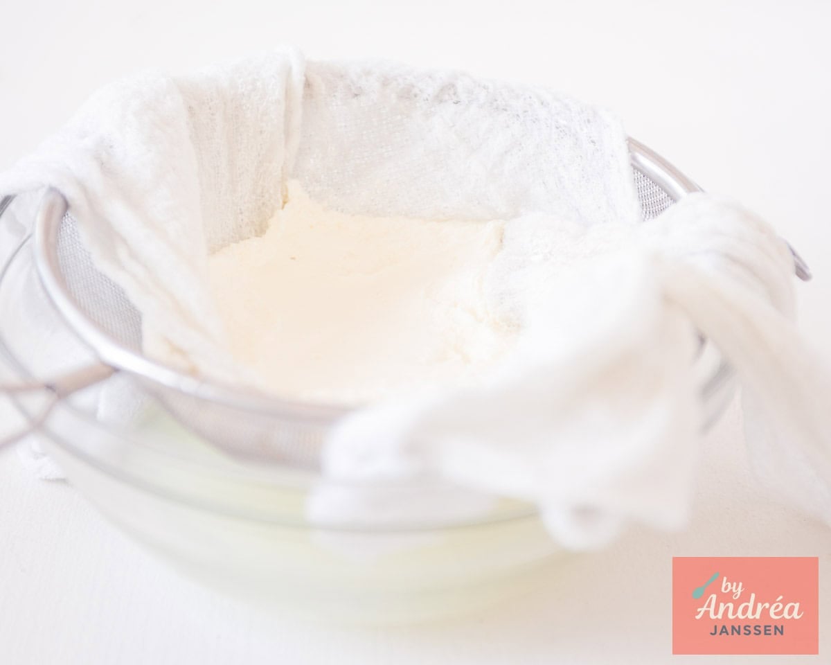 Let the full-fat yogurt drain in a sieve lined with cheesecloth.