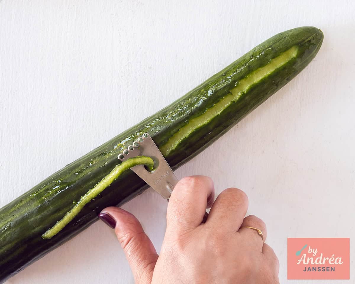 Decorate the cucumber with a zester.