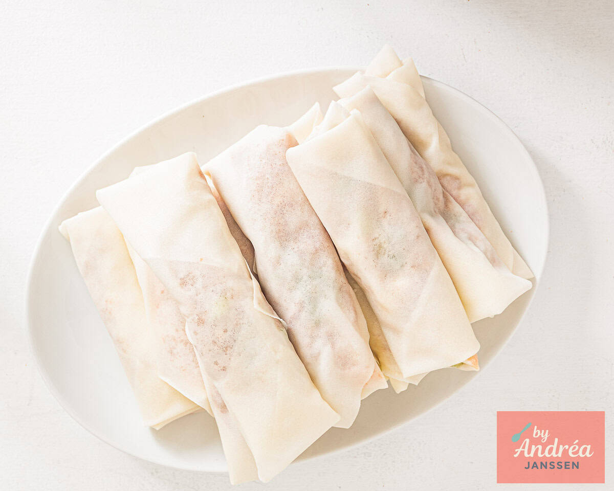 Roll every spring roll and prepare to fry.