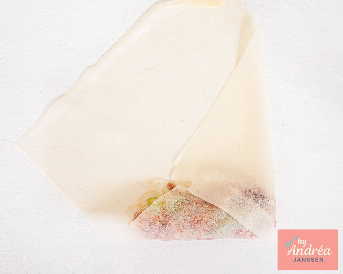 Fold the spring roll wrapper around the filling.
