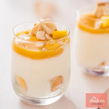 A square photo with two small glasses of White Chocolate Mousse with Mango Jelly