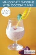 A glass with smoothie with mango, date, oatmeal and coconut on a yellow background. A text: easy recipe: mango date smoothie with coconut milk
