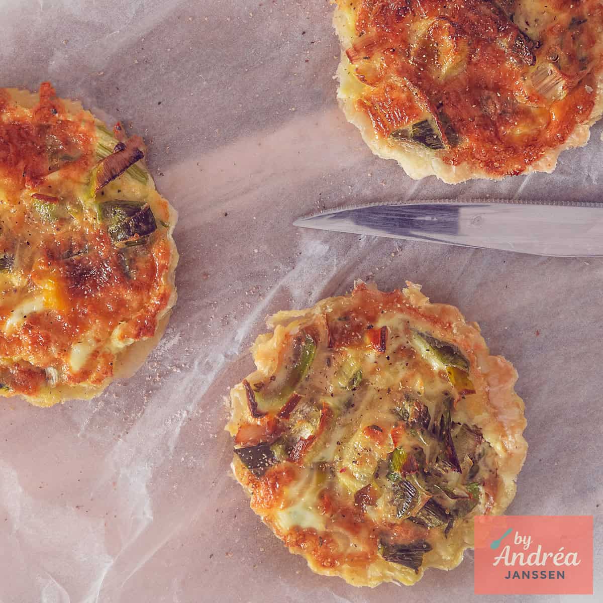 A square photo taken from above showing three quiches with mackerel, leek, cheese and thyme