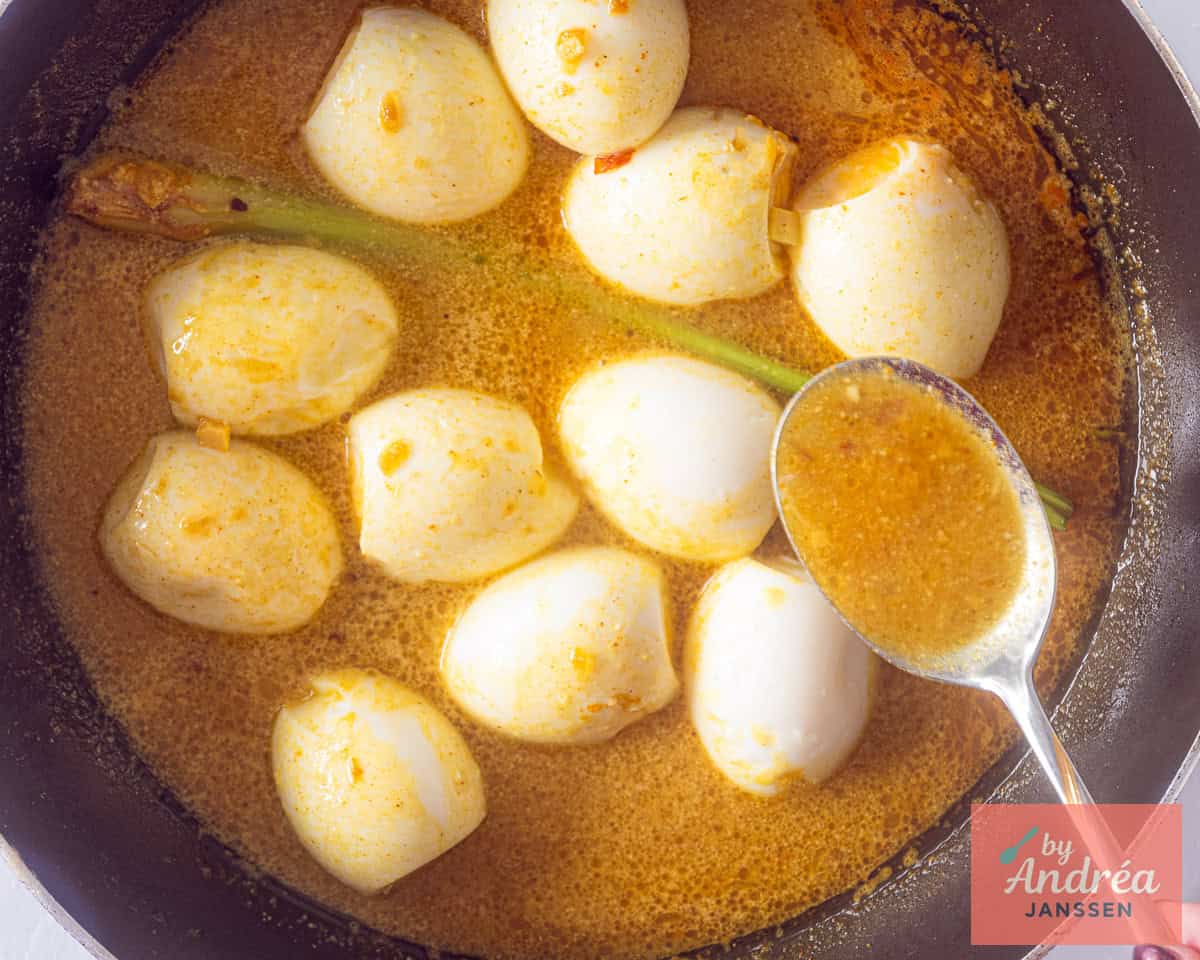 Spoon some coconut sauce on the hardboiled eggs in a skillet