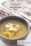 A gray bowl filled with spinach soup and vegan feta cubes. A text overlay describes the photo