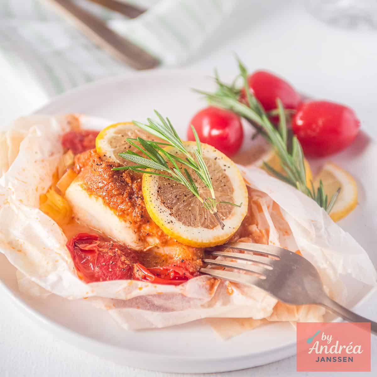 Square picture with easy baked cod packets on a white plate