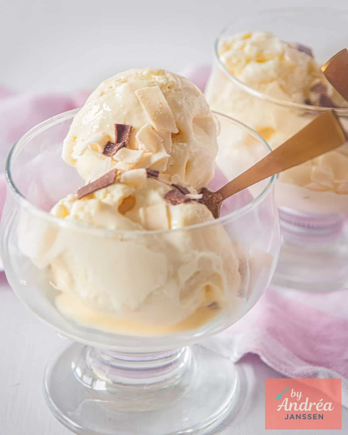 White chocolate ice cream balls in a glass with some chocolate sprinkles