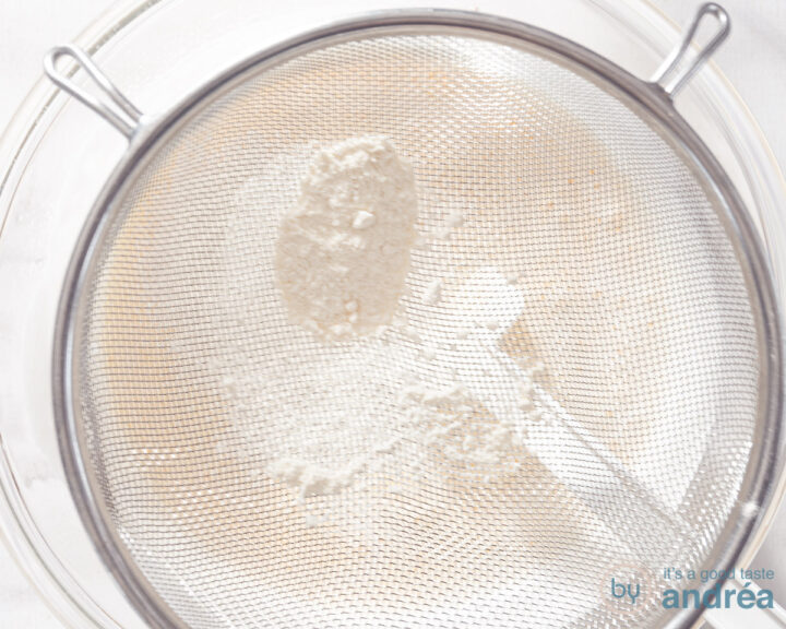 Sieving flour above the batter