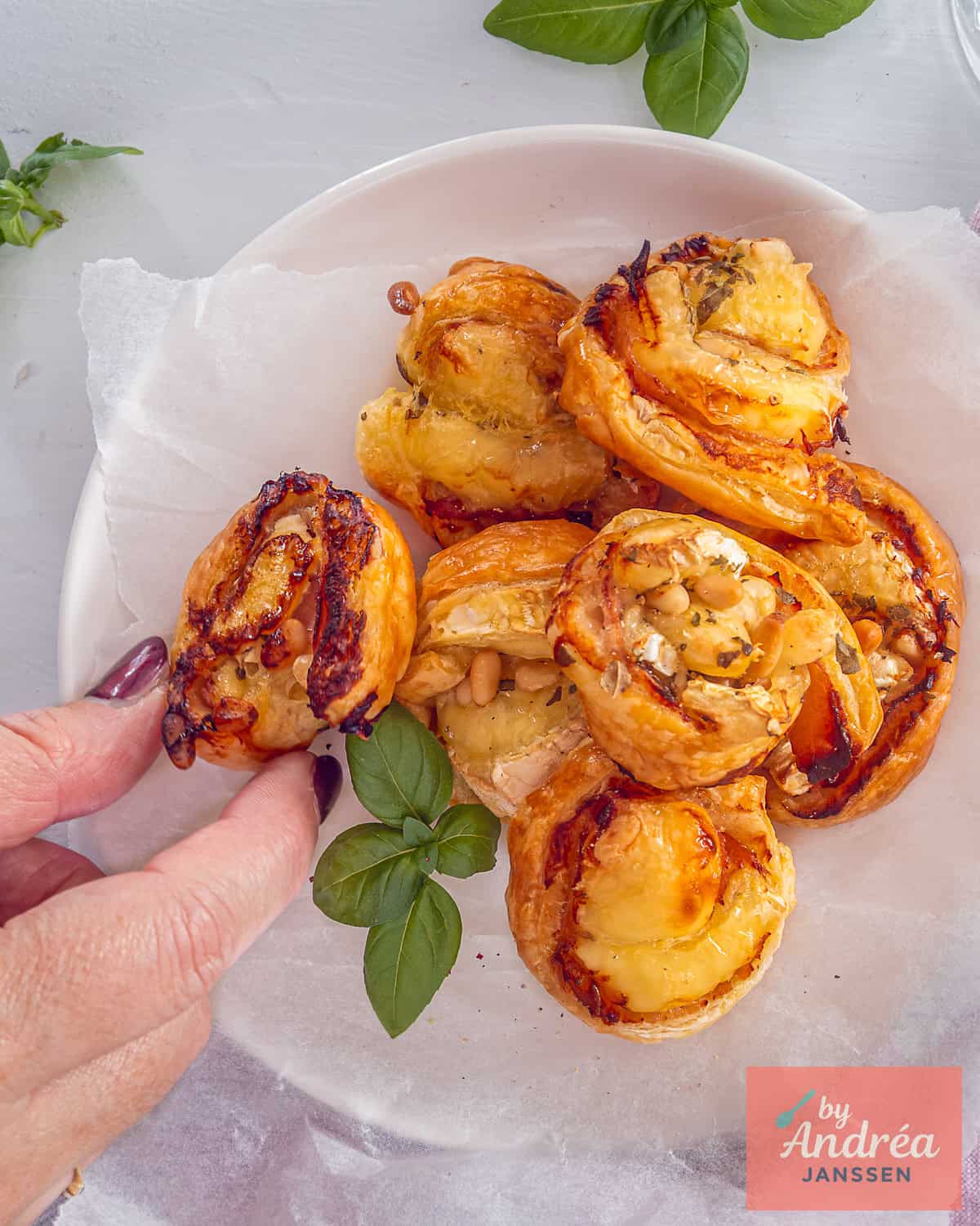 A photo from above of a platter of puff pastry bites with bacon and cheese