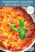 Part of a casserole filled with meat sauce lasagna and topped with basil. A text: easy recipe, homemade lasagna with meat sauce