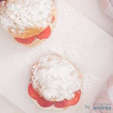 A square photo of two scones photographed from above with a white background.