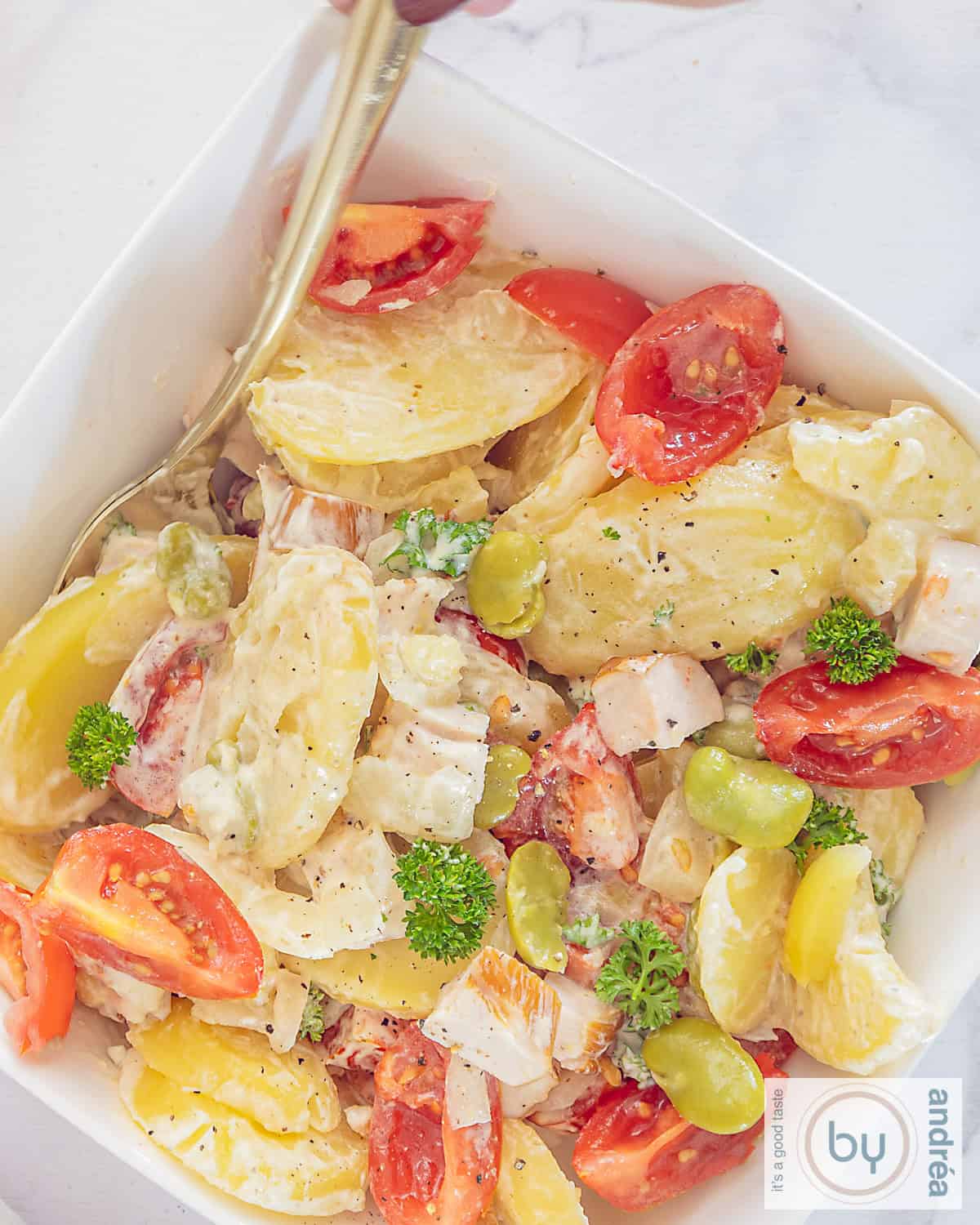 A photo from above of a bowl of lean potato salad with lots of vegetables