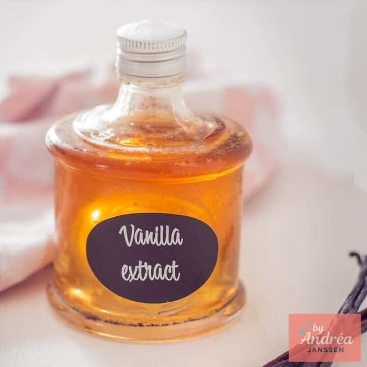 A square picture with a glass bottle filled with homemade vanilla extract.