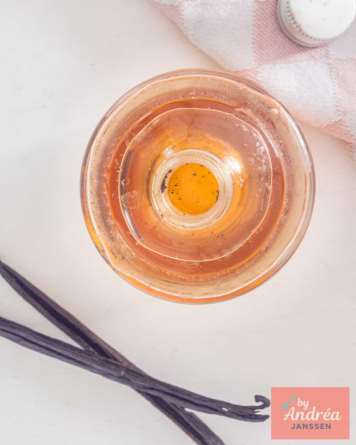 A picture from above of a glass bottle filled with vanilla extract made from scratch