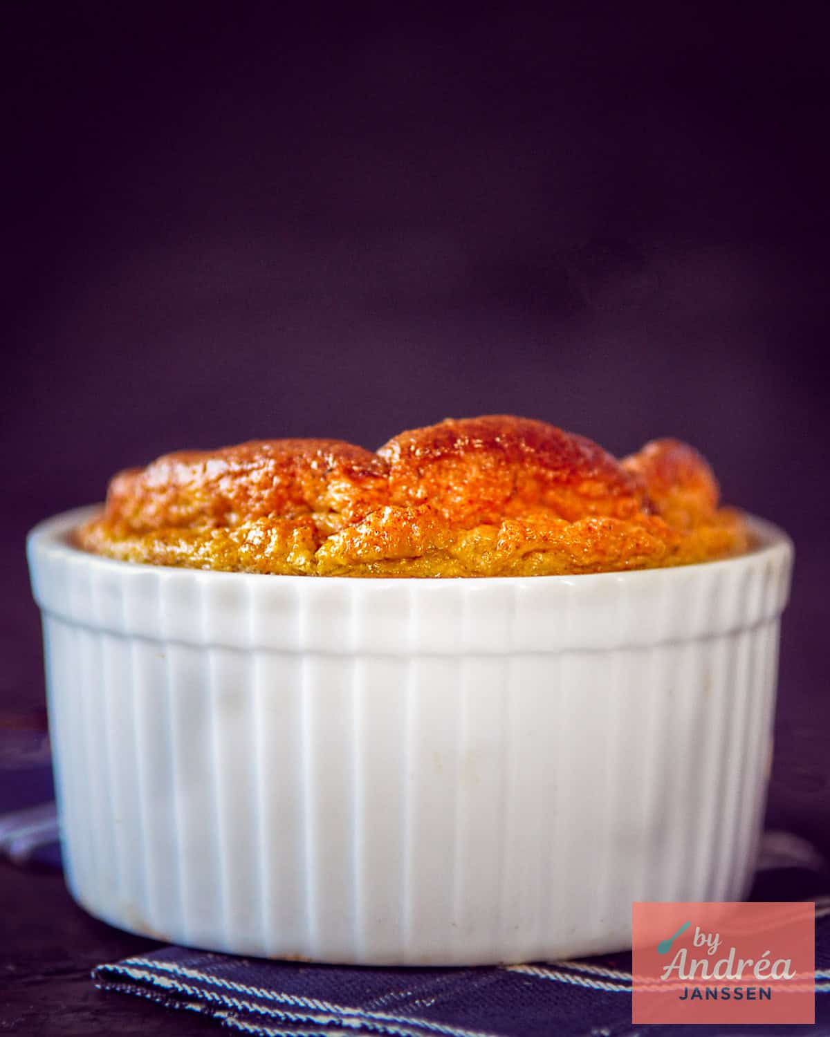 A photo of a white baking dish with a Jerusalem artichoke soufflé that has risen beautifully.
