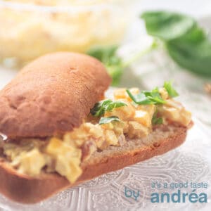 a square photo with an Italian baguette topped with mango chicken salad