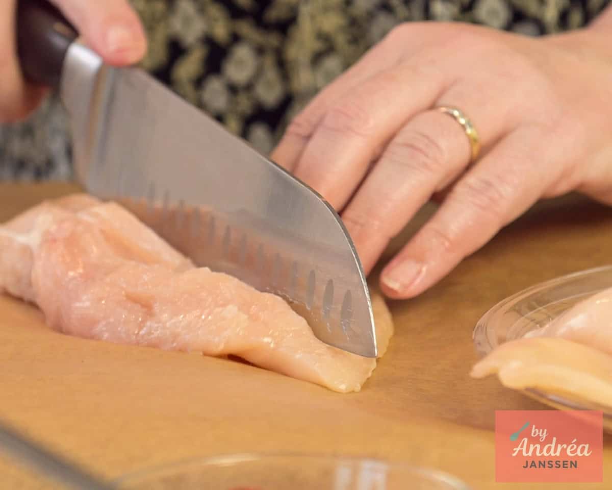 Chicken fillet is cut open until a pocket is formed.