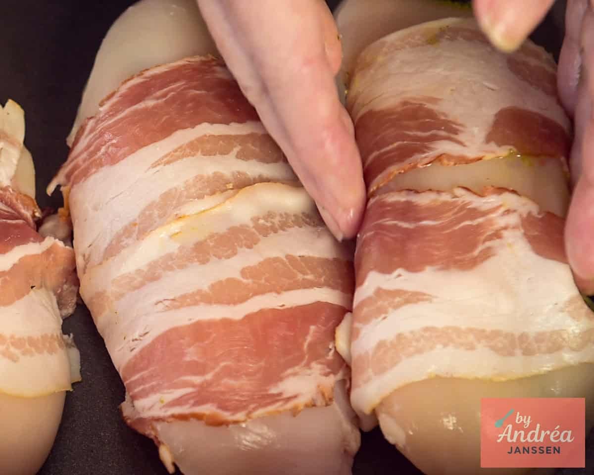 A baking dish in which a stuffed chicken fillet with bacon is rolled is placed.