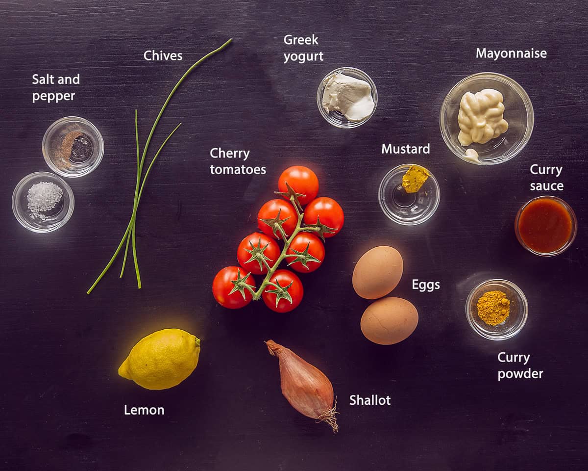 Ingredients Egg Salad Stuffed Tomatoes on a black background with text description