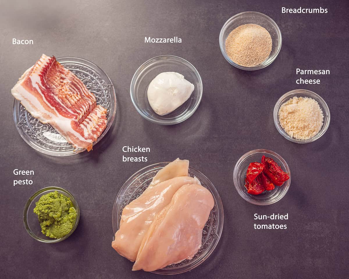 Ingredients Pesto Stuffed Chicken Breast With Mozzarella on a black background with text description