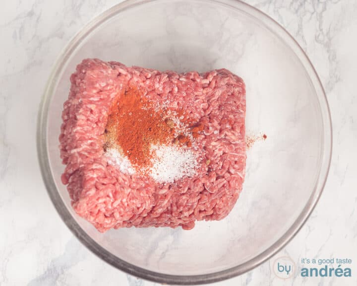 Ground beef with spices in a glass bowl
