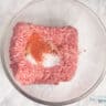 Ground beef with spices in a glass bowl