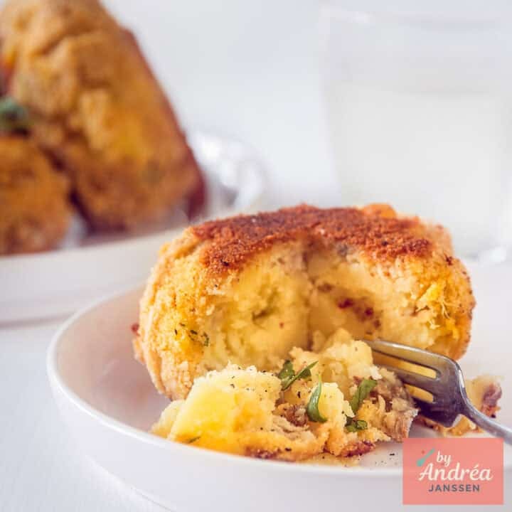 A square picture with a smoked mackerel fish cake. A bite taken off.