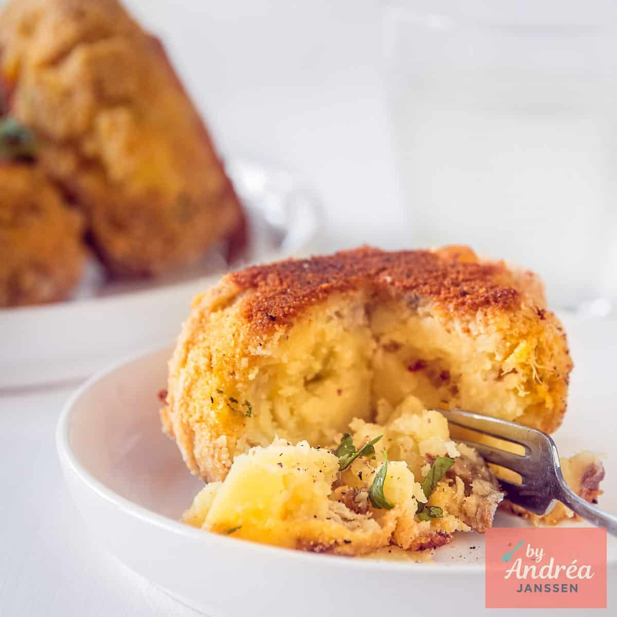 A square picture with a smoked mackerel fish cake. A bite taken off.