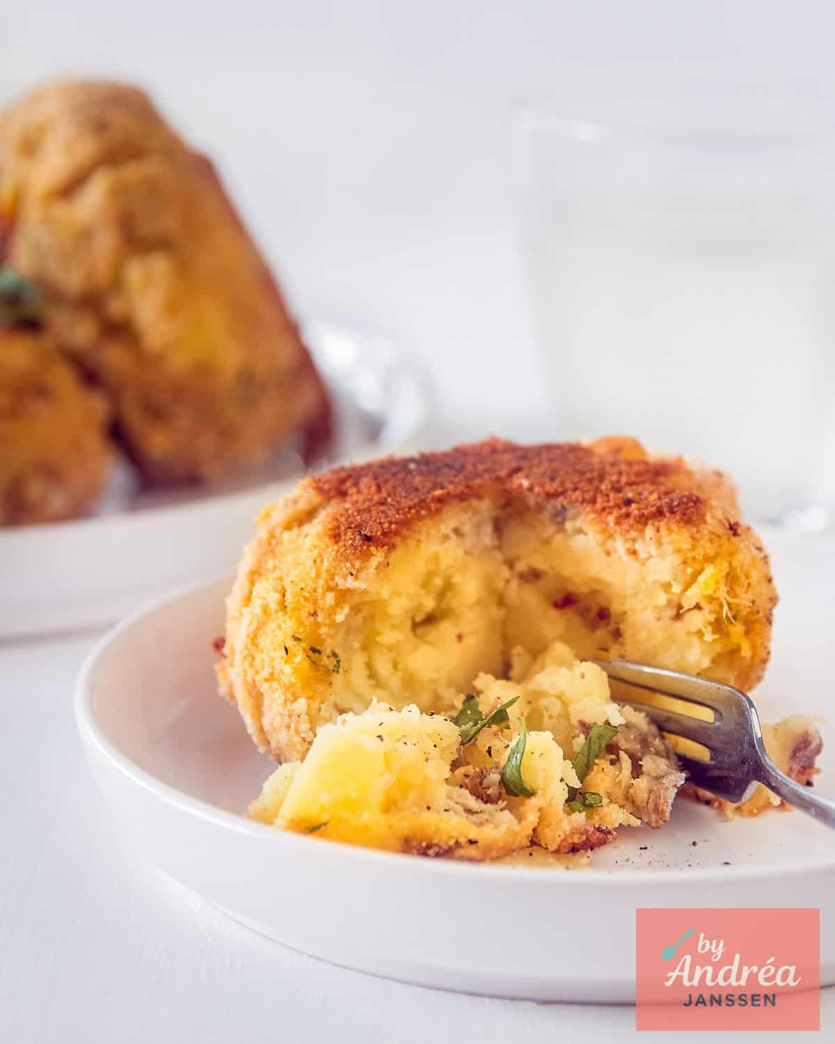 A smoked mackerel fish cake where the inside with potatoes and mackerel is visible.