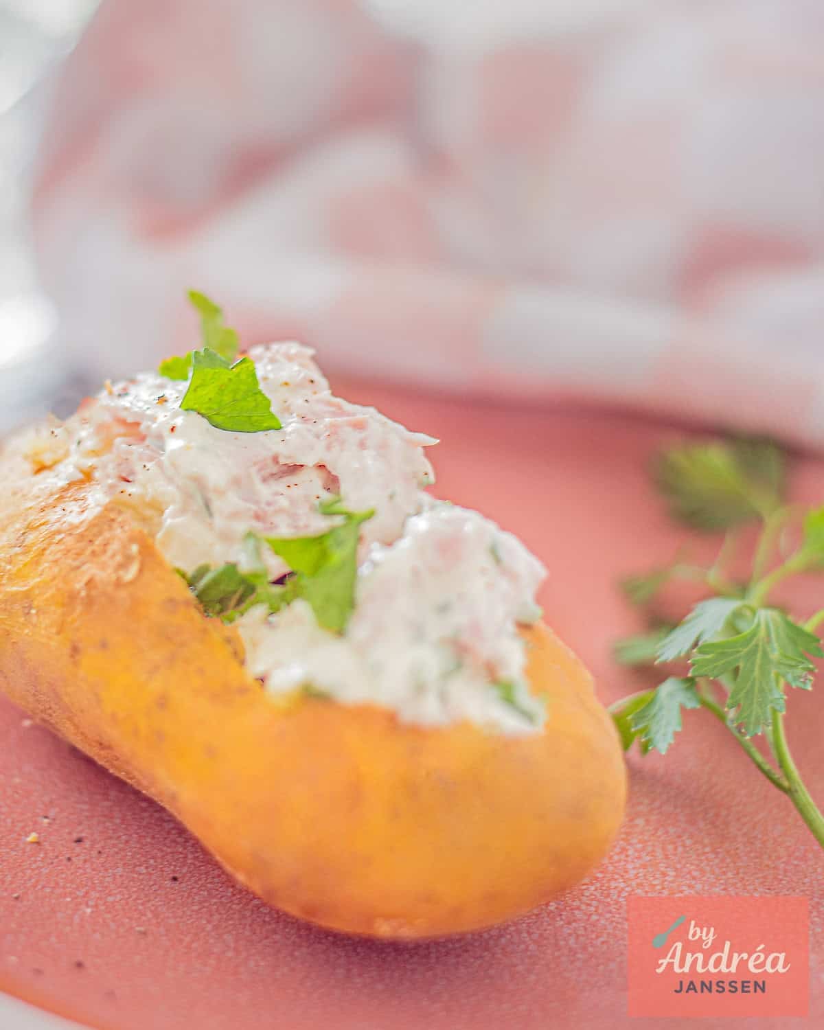 A baked potato filled with quark, ham, and herbs