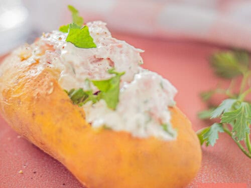 A square photo with a baked potato with quark and ham