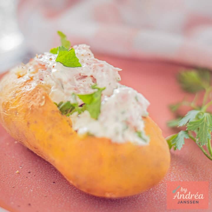 A square photo with a baked potato with quark and ham